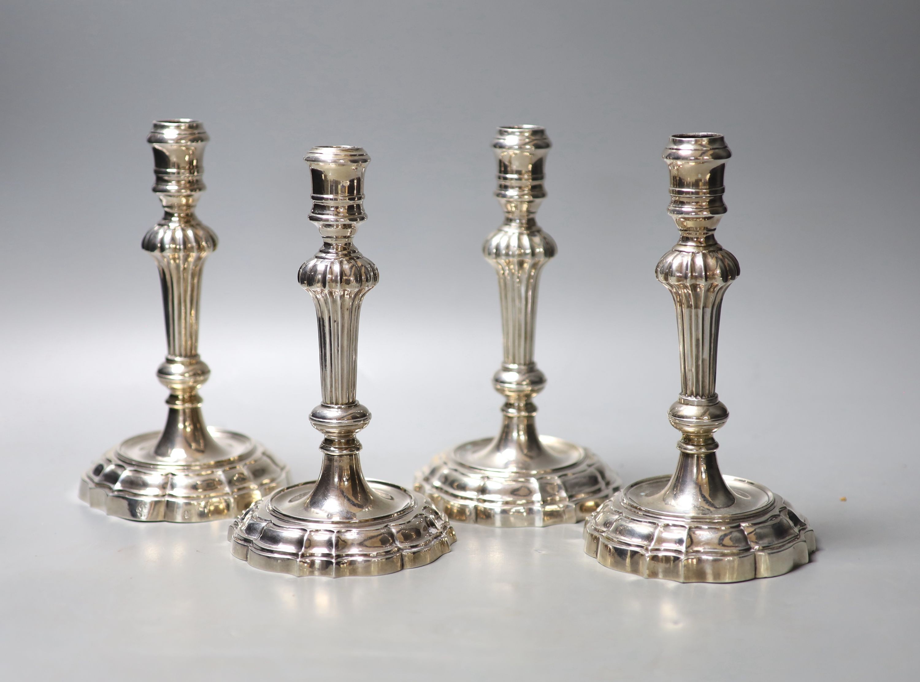 A matched set of four late 18th/early 19th century Italian? cast white metal candlesticks